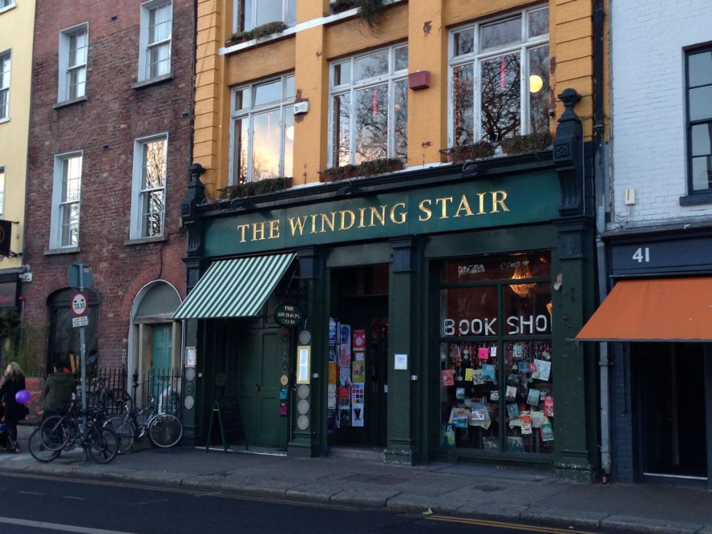 street view of book shop with green striped awning