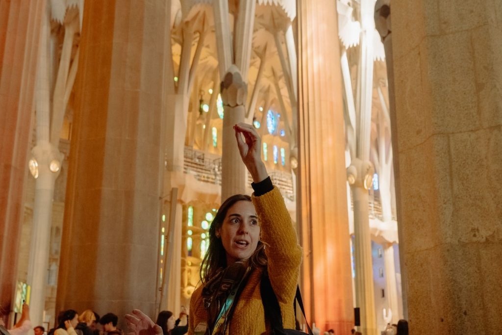 guide talking to a group inside a church in barcelona