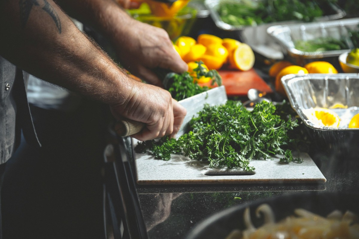 Person slicing Parsley in Paris