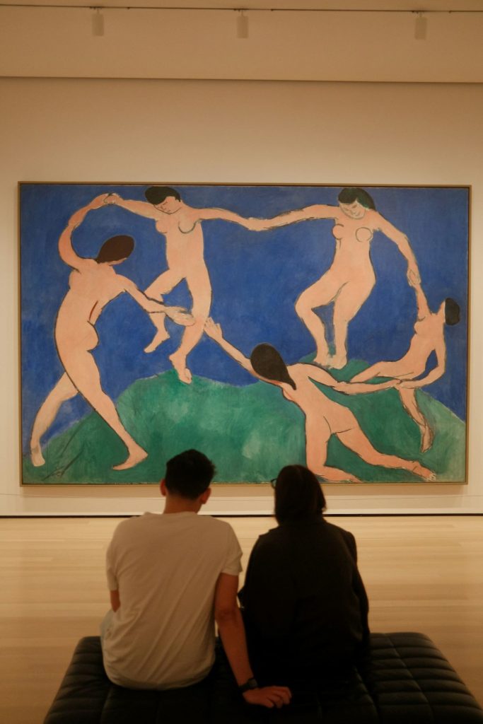 People looking at Matisse’s”Dance and the MoMA. 