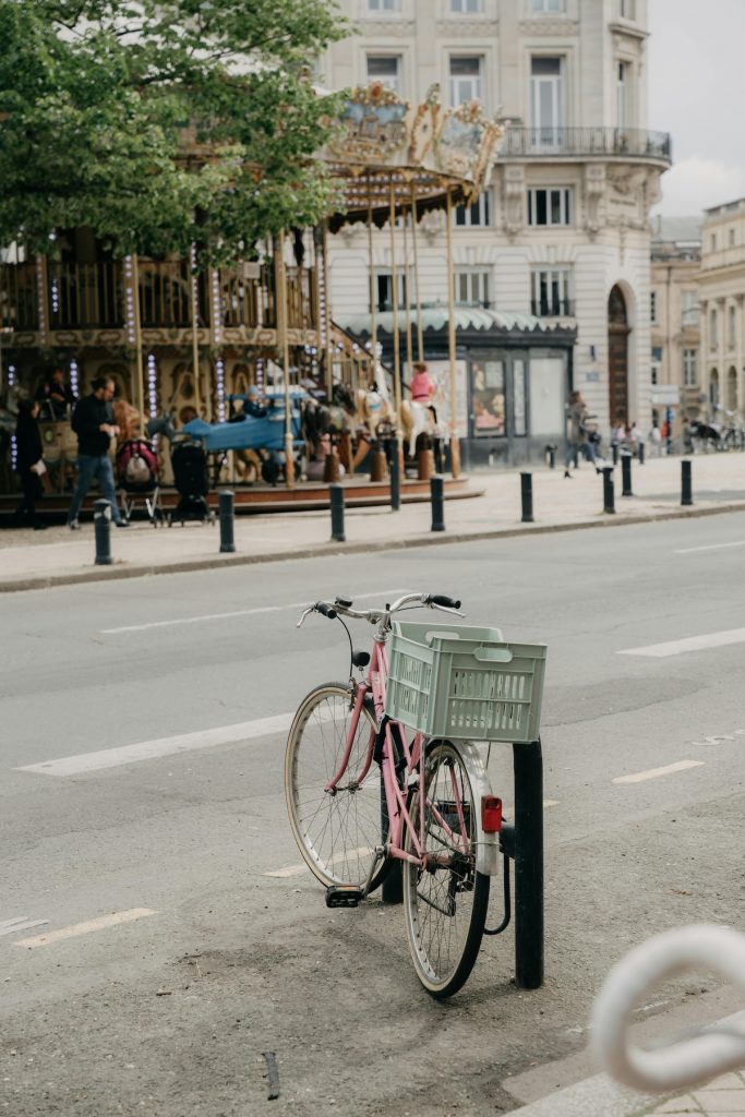 a bike leaning against a stand on a street