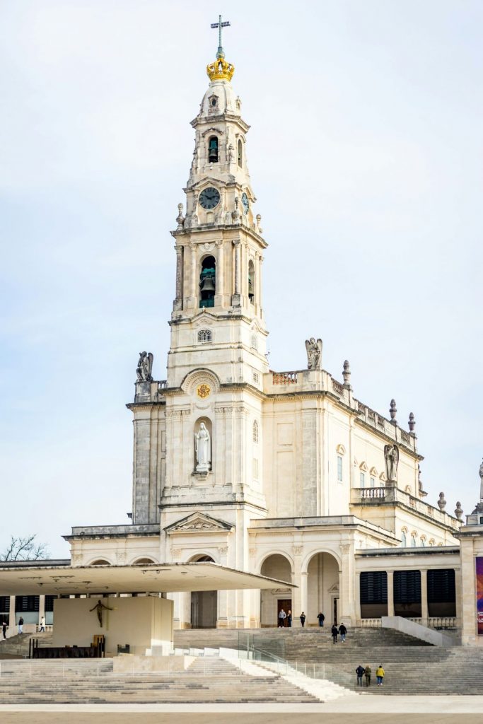 People walking into
Sanctuary of Our Lady of Fátima in Fátima, Portugal.