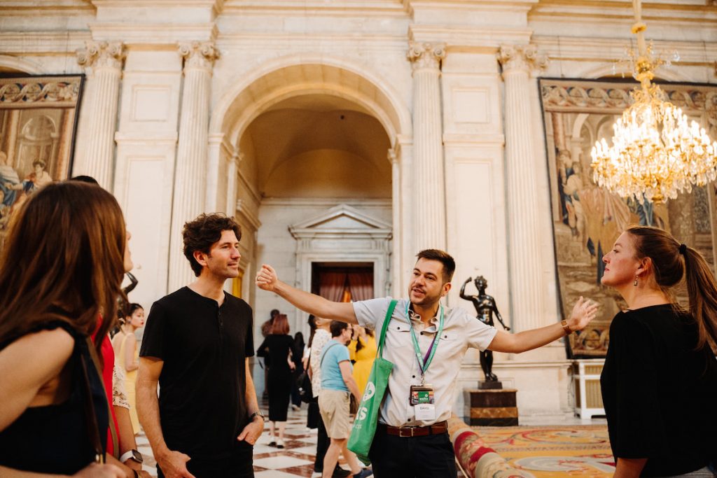Tour guide explains Palacio Real to a group in Madrid