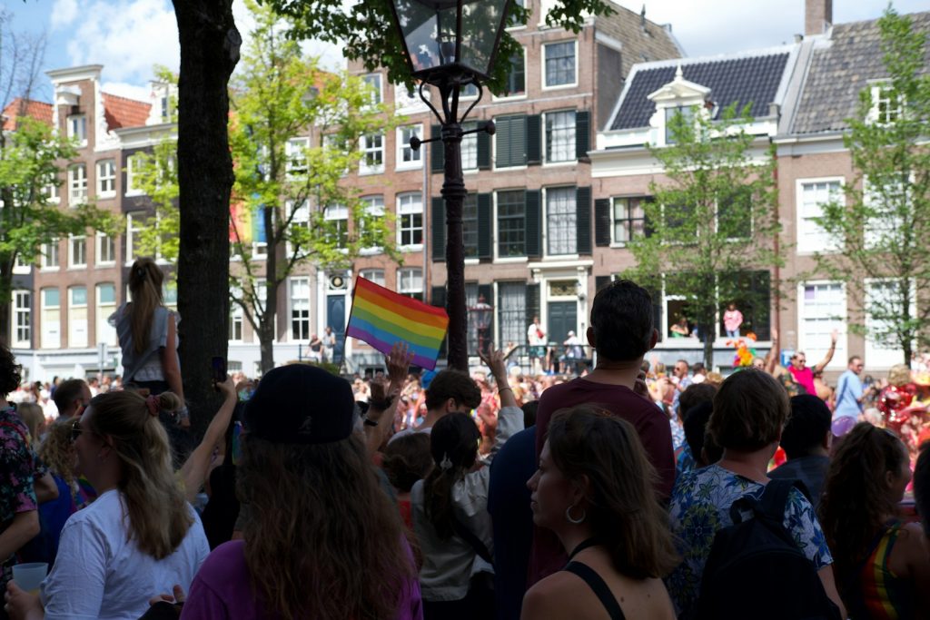 a crowd of people standing around each other
