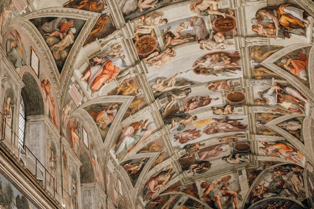 Michelangelo’s frescoes fill the Sistine Chapel ceiling in Vatican City, depicting biblical stories with vivid, detailed figures and movement.