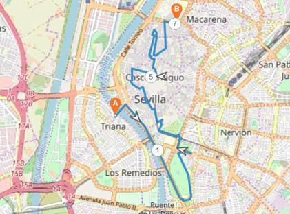 A map of Seville, Spain, displays a marked route from Triana to Macarena passing city center points