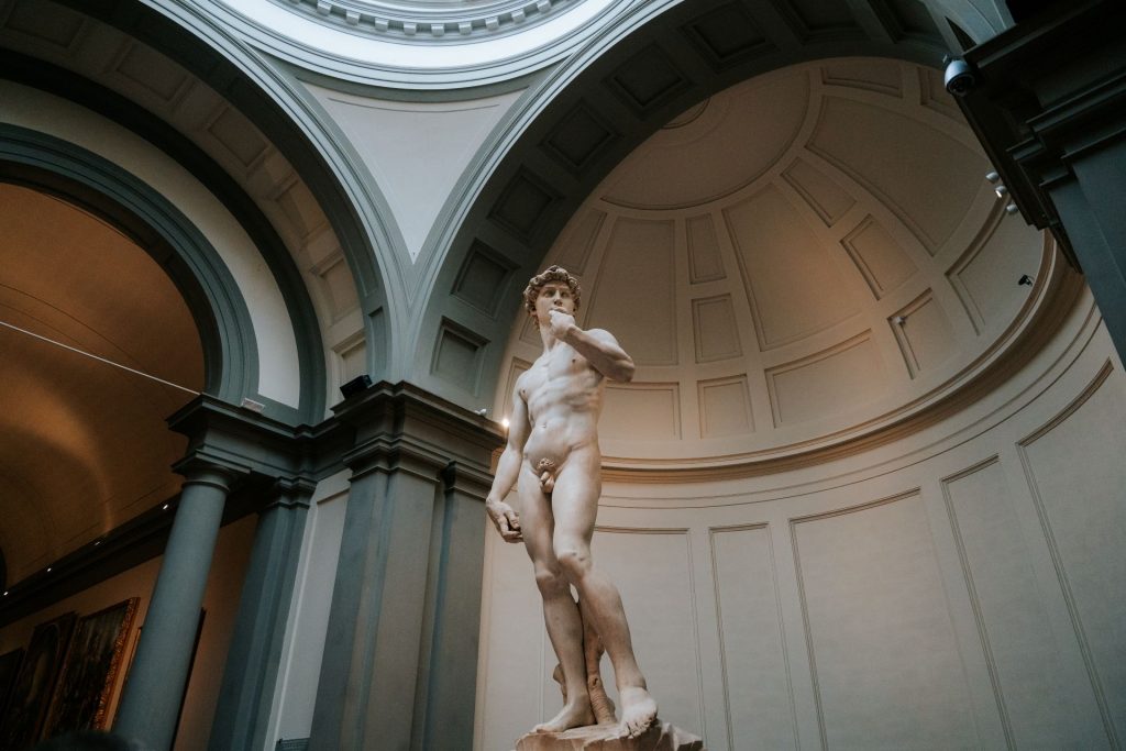 Michelangelo’s marble David stands beneath a domed ceiling at Florence’s Galleria dell’Accademia, beautifully lit by daylight. Enjoy skip the line access as part of an overnight trip from Rome.